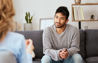 young man talking to therapist