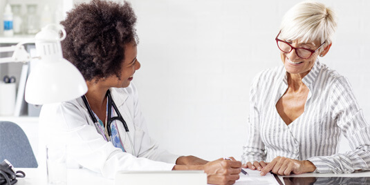 female internal medicine doctor talking to patient