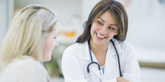 female internal medicine doctor talking to patient