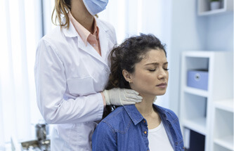 doctor examining patient's thyroid gland