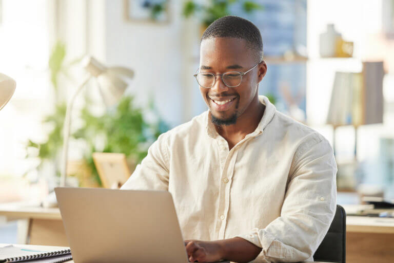 young man typing on his laptop